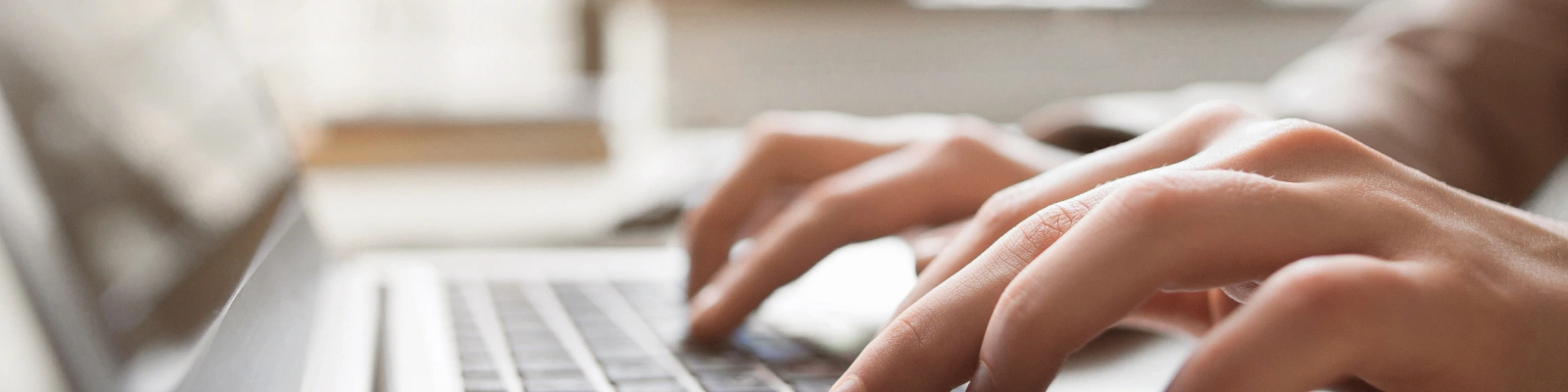 hands typing on a laptop
