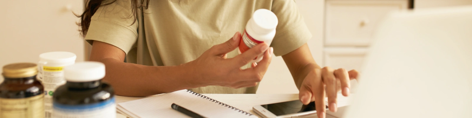 person holding a bottle of pills